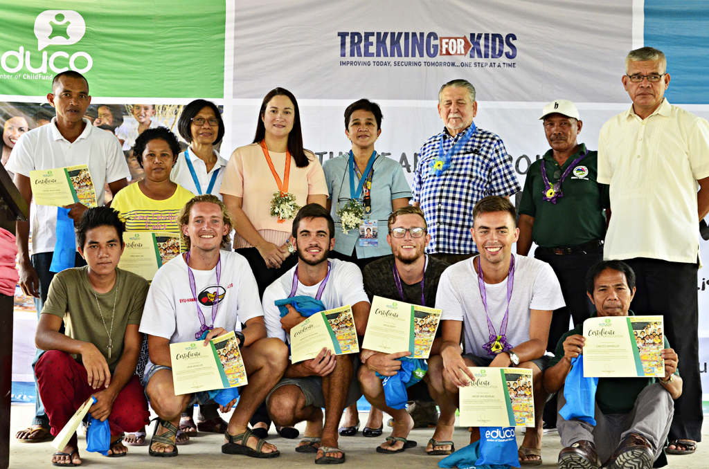 Local volunteers from Barangay Pinit and foreign TFKI volunteers from the US pose with Project HeaR stakeholder representatives. Third from left to right: Nancy Obias, Educo Program Manager (white); Ligao City Mayor Patricia Alsua (peach); DepEd SDS Ma. Luisa Samaniego (light blue green); Congressman Fernando Gonzalez (checkered); Pinit Brgy. Captain Herculano Prena (dark green); and, Principal Fernando Murillo of Pinit ES (cream). 